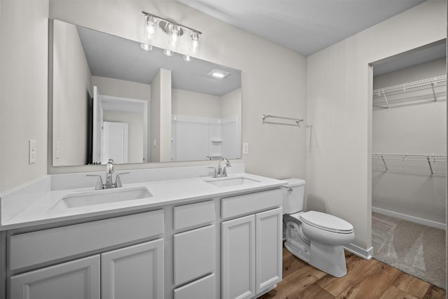 bathroom featuring vanity, hardwood / wood-style floors, and toilet