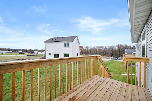 wooden deck featuring a lawn