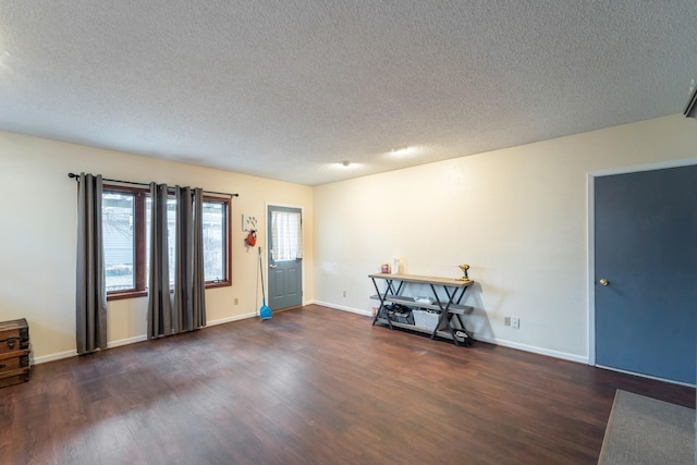 interior space featuring dark hardwood / wood-style floors and a textured ceiling