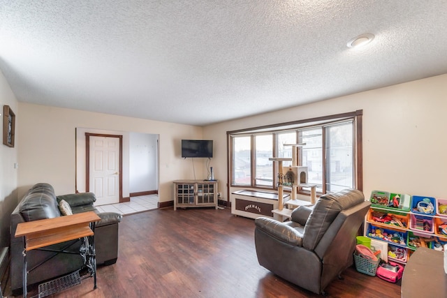 living room featuring dark hardwood / wood-style flooring and a textured ceiling