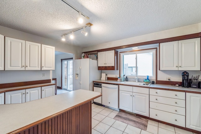 kitchen with white cabinetry, sink, white appliances, and a healthy amount of sunlight