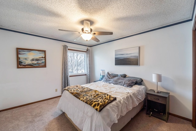 bedroom with ceiling fan, carpet floors, ornamental molding, and a textured ceiling