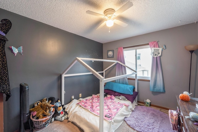 bedroom featuring ceiling fan, carpet floors, and a textured ceiling