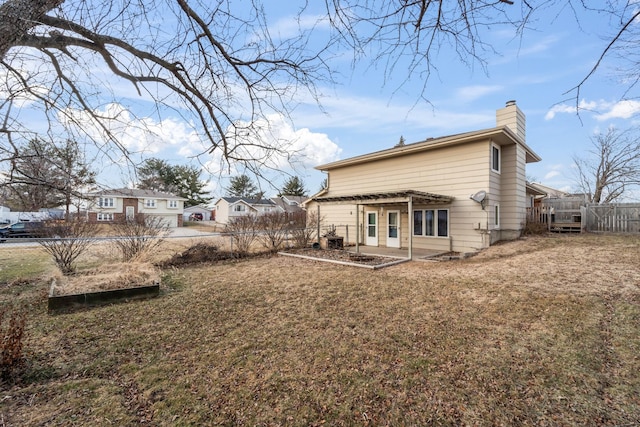 back of house featuring a yard and a pergola