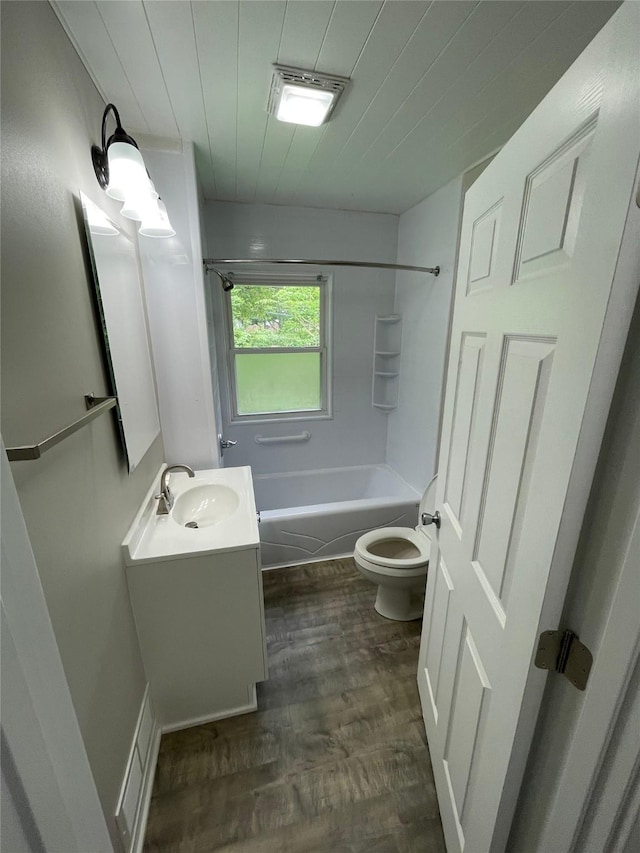 full bathroom with vanity, shower / bathing tub combination, hardwood / wood-style floors, and toilet