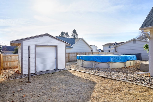 view of yard featuring a storage unit and a covered pool