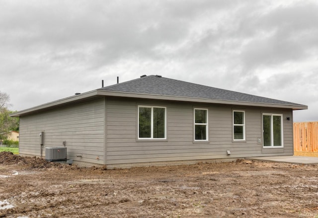 rear view of property featuring a patio and central air condition unit