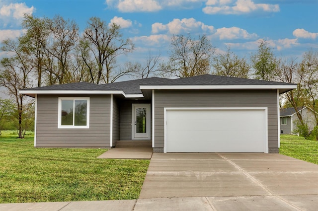 view of front of home featuring a garage, concrete driveway, and a front yard