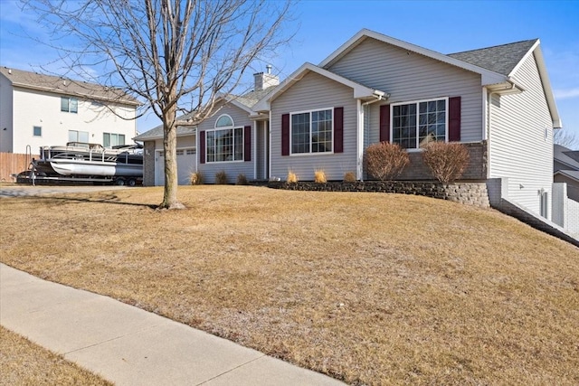 view of front facade featuring a garage and a front lawn