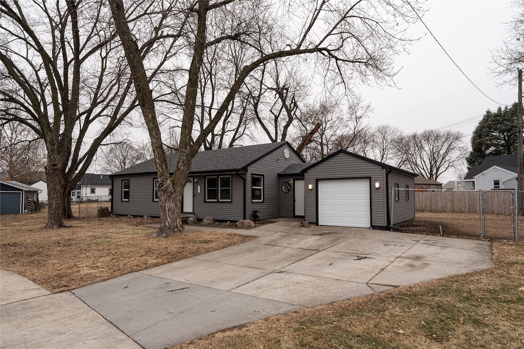 single story home with a garage and a front yard