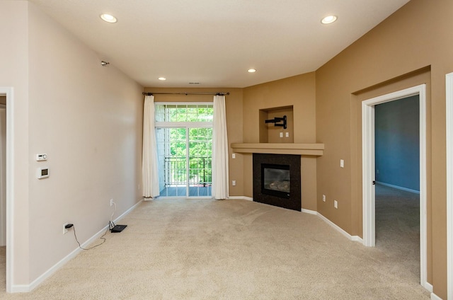 unfurnished living room featuring light colored carpet and a fireplace