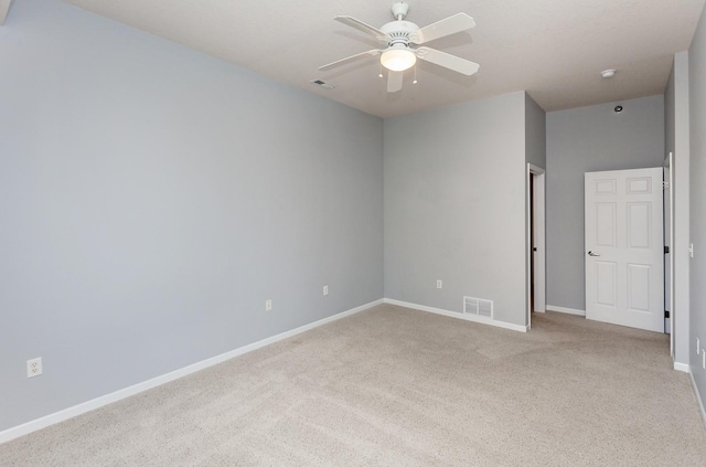 spare room featuring ceiling fan and light colored carpet