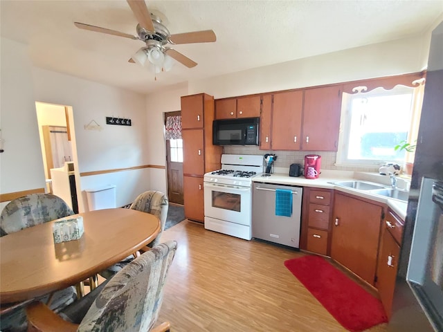 kitchen with sink, plenty of natural light, white range with gas stovetop, and dishwasher