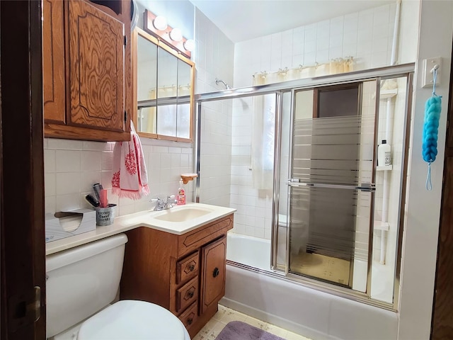 full bathroom with tasteful backsplash, vanity, combined bath / shower with glass door, and toilet