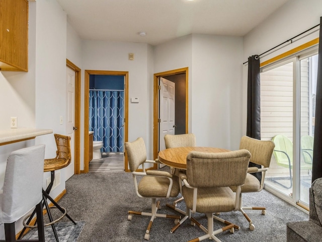 dining room with carpet and a wealth of natural light