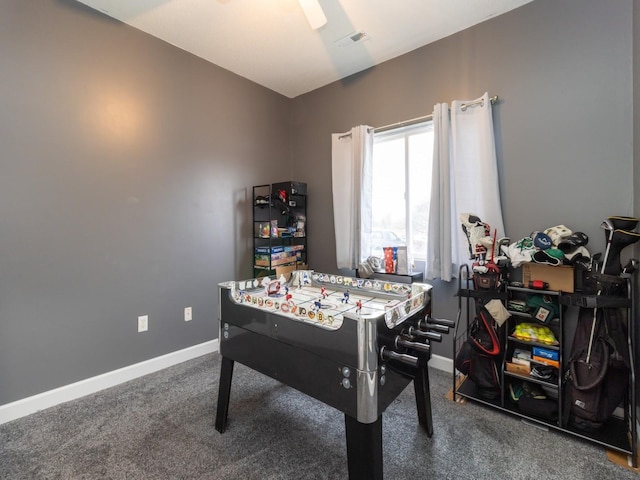 game room with dark colored carpet