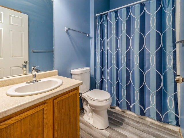 bathroom with vanity, hardwood / wood-style floors, and toilet