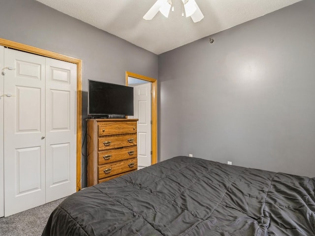 carpeted bedroom with a closet and ceiling fan