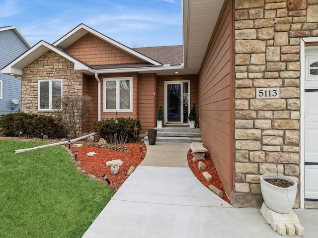 property entrance featuring a lawn