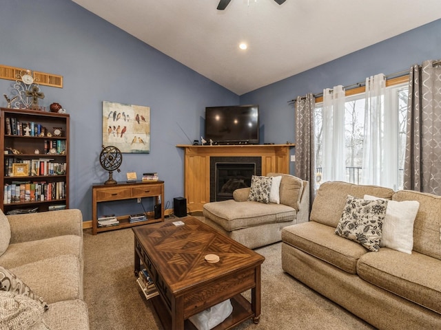 carpeted living room with lofted ceiling and ceiling fan