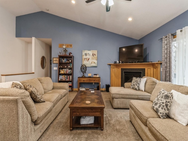 carpeted living room featuring vaulted ceiling and ceiling fan