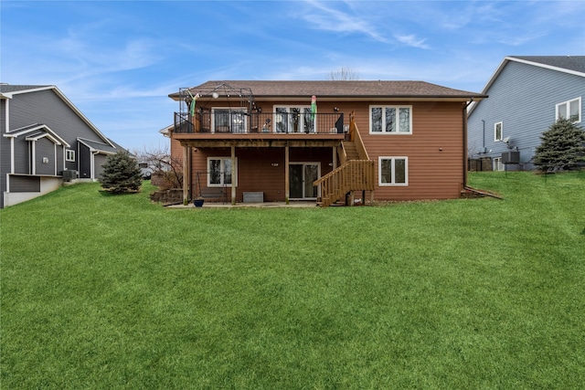 back of house featuring a wooden deck, central AC unit, and a lawn