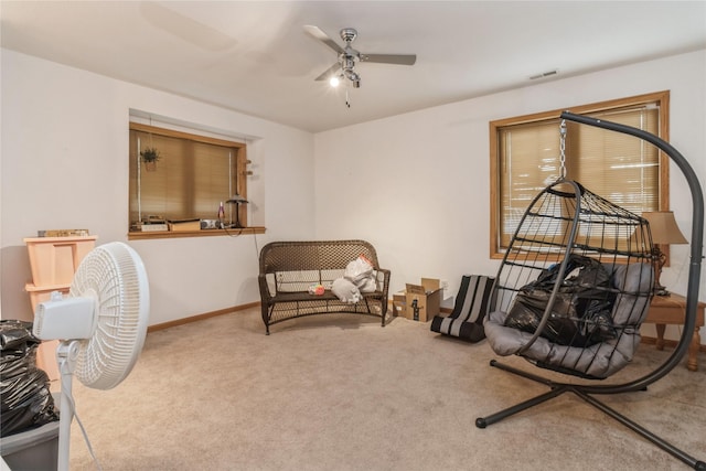 sitting room with carpet flooring and ceiling fan