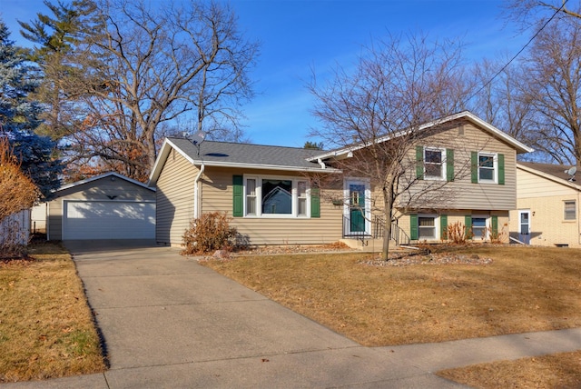 tri-level home featuring an outbuilding, a garage, and a front yard