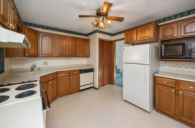 kitchen featuring sink, white appliances, a textured ceiling, and ceiling fan