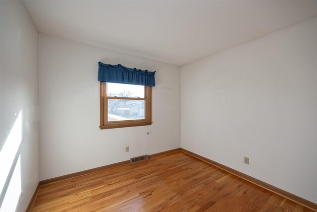 empty room with hardwood / wood-style floors