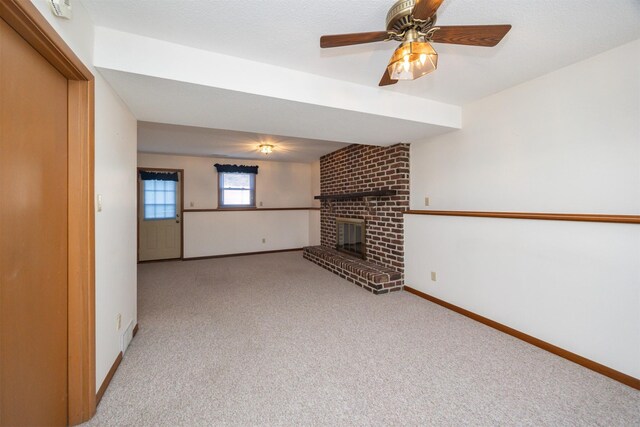 unfurnished living room with light carpet, a fireplace, and ceiling fan