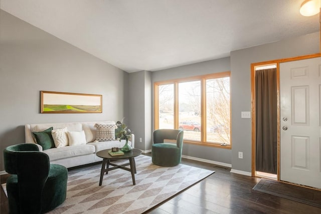 living room featuring dark hardwood / wood-style floors and vaulted ceiling