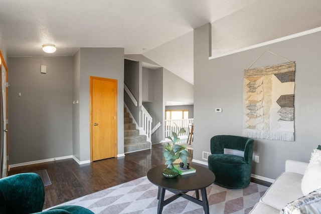 living room with lofted ceiling and dark hardwood / wood-style floors