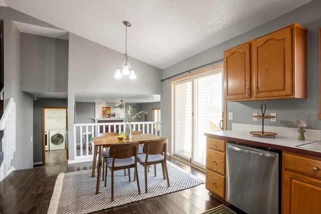 kitchen with decorative light fixtures, separate washer and dryer, vaulted ceiling, dark hardwood / wood-style flooring, and dishwasher