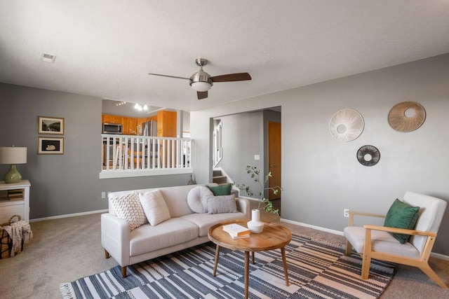 carpeted living room featuring ceiling fan