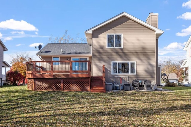 rear view of house with a deck and a lawn