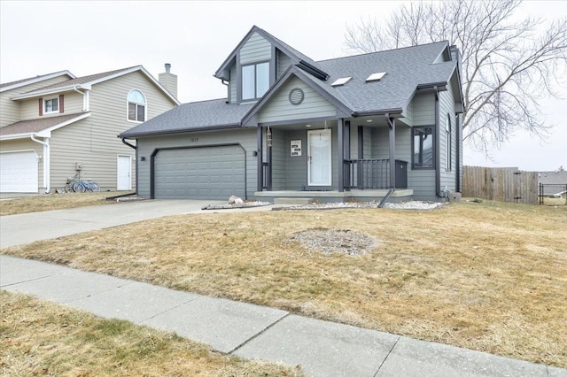 view of front of property with a garage, covered porch, and a front yard