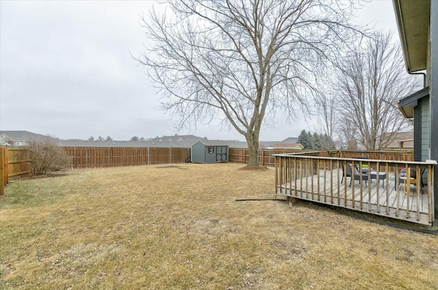 view of yard featuring a shed and a wooden deck