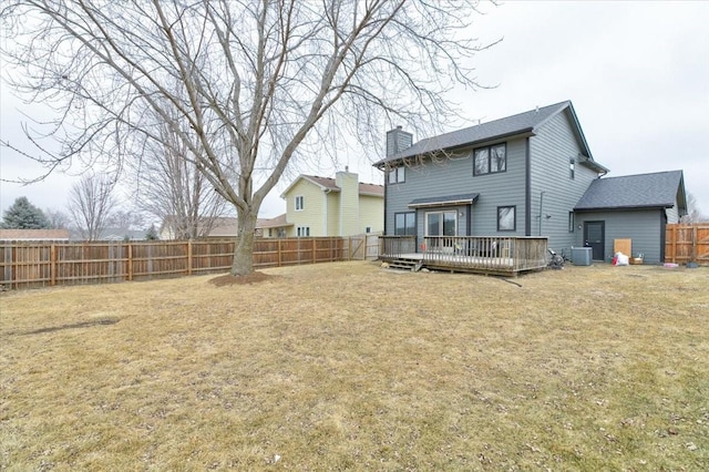 rear view of property featuring a yard, central AC, and a deck