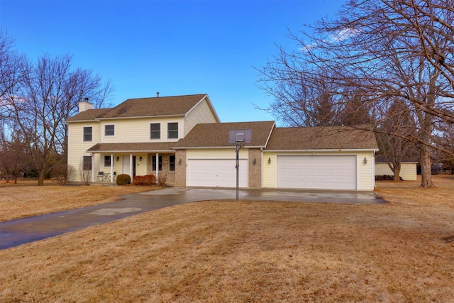 view of front of home with a garage and a front lawn