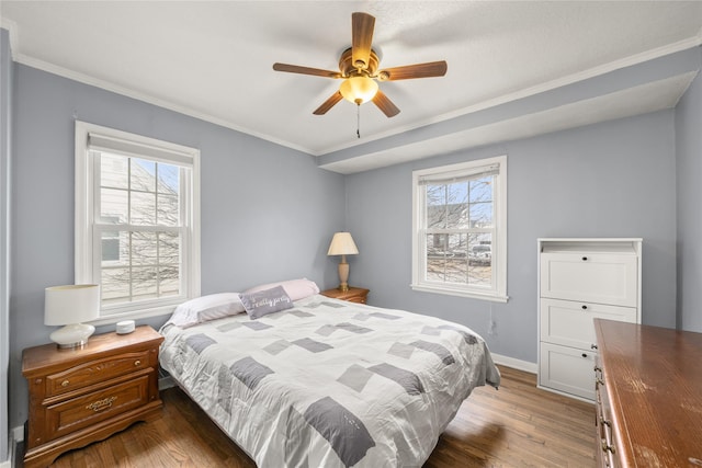 bedroom with crown molding, dark hardwood / wood-style floors, and multiple windows