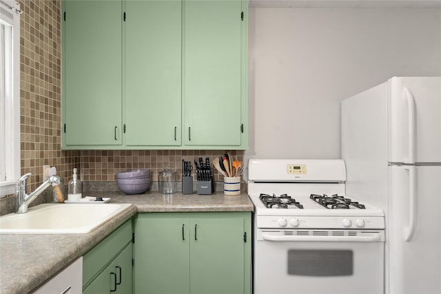 kitchen with backsplash, white appliances, sink, and green cabinetry