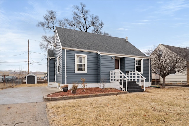 view of front facade featuring a front yard and a storage unit