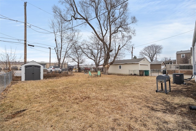 view of yard with central AC and a shed