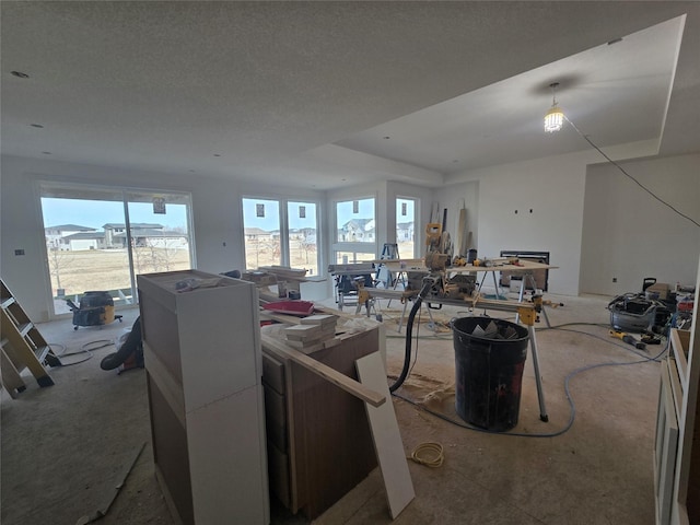 living area featuring a textured ceiling