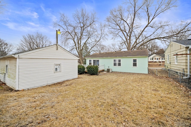 back of property featuring a yard and central AC unit