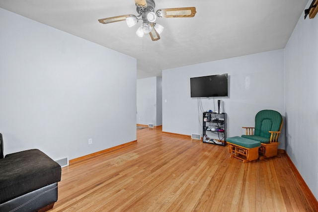 sitting room with ceiling fan and light hardwood / wood-style flooring