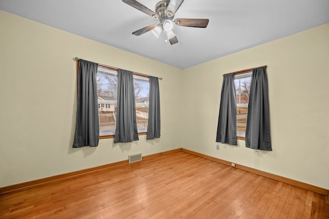 empty room with wood-type flooring and ceiling fan