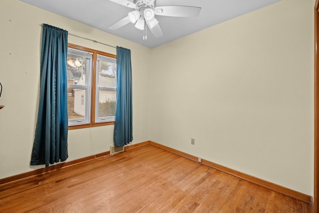 spare room featuring wood-type flooring and ceiling fan