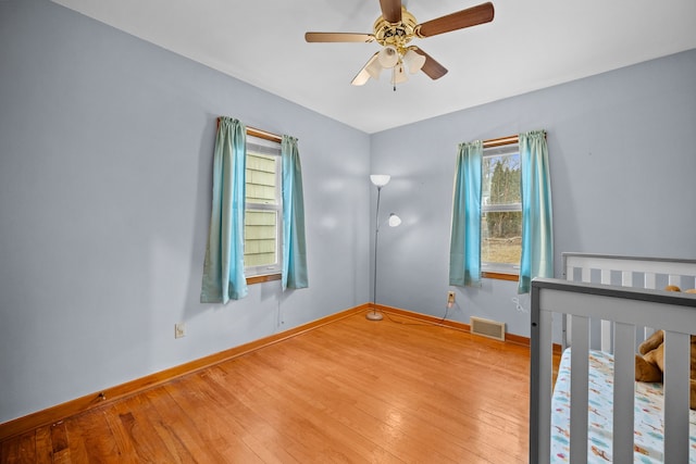 unfurnished bedroom featuring wood-type flooring and ceiling fan